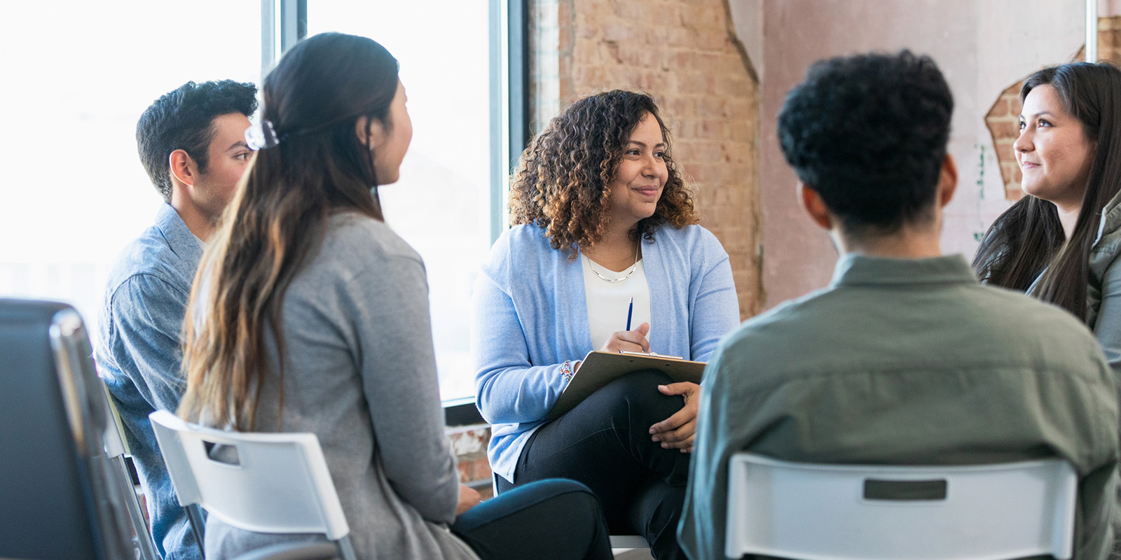 Young people sitting in circle having a conversation